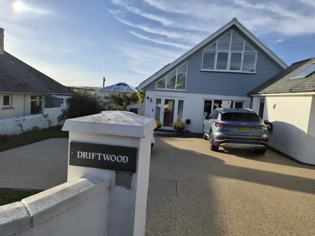 The house at Driftwood, with its name sign